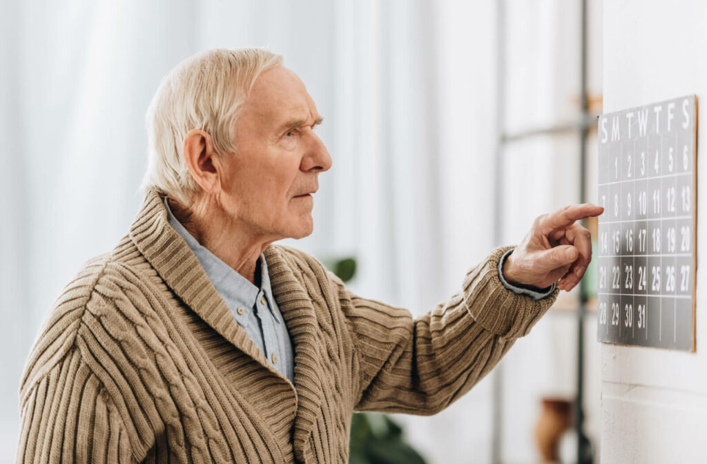 An old man looking at a calendar and remembering dates.