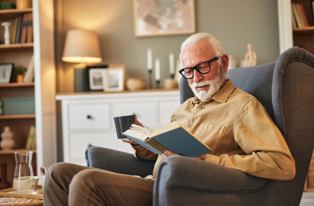 A person sits comfortably and reads their book while they enjoy an afternoon coffee.